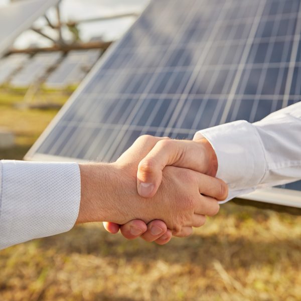 businessmen-shaking-hands-near-solar-power-station-2022-11-23-00-45-18-utc_Easy-Resize.com